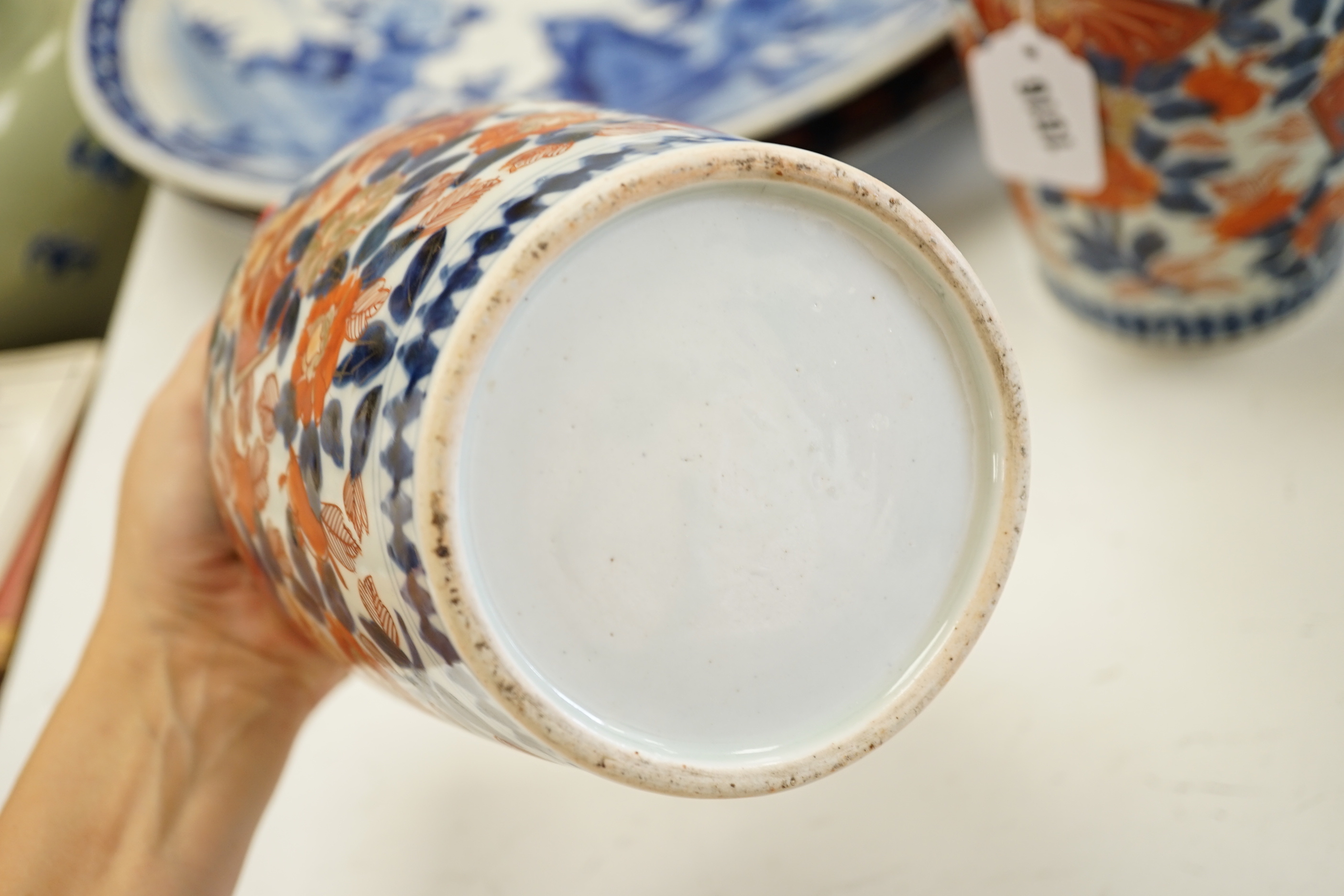 A pair of 19th century Japanese Imari vases, a similar charger, an earlier cracked and riveted charger and a blue and white charger, (5), largest charger 47cm diameter